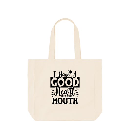White tote bag with "I Have A Good Heart But This Is My Mouth" text