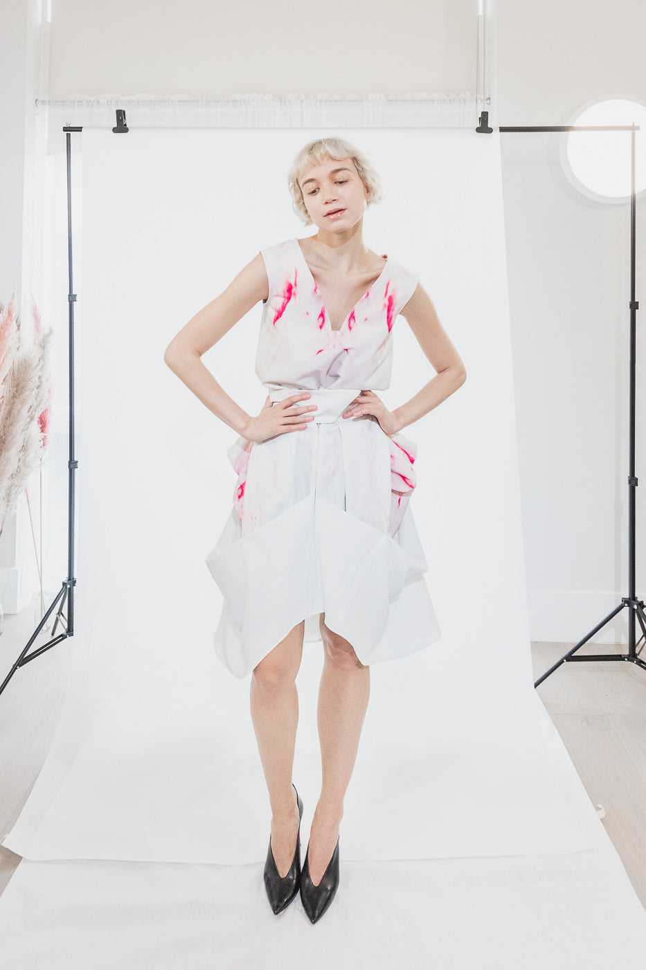 Asymmetric white dress with red floral pattern (person)