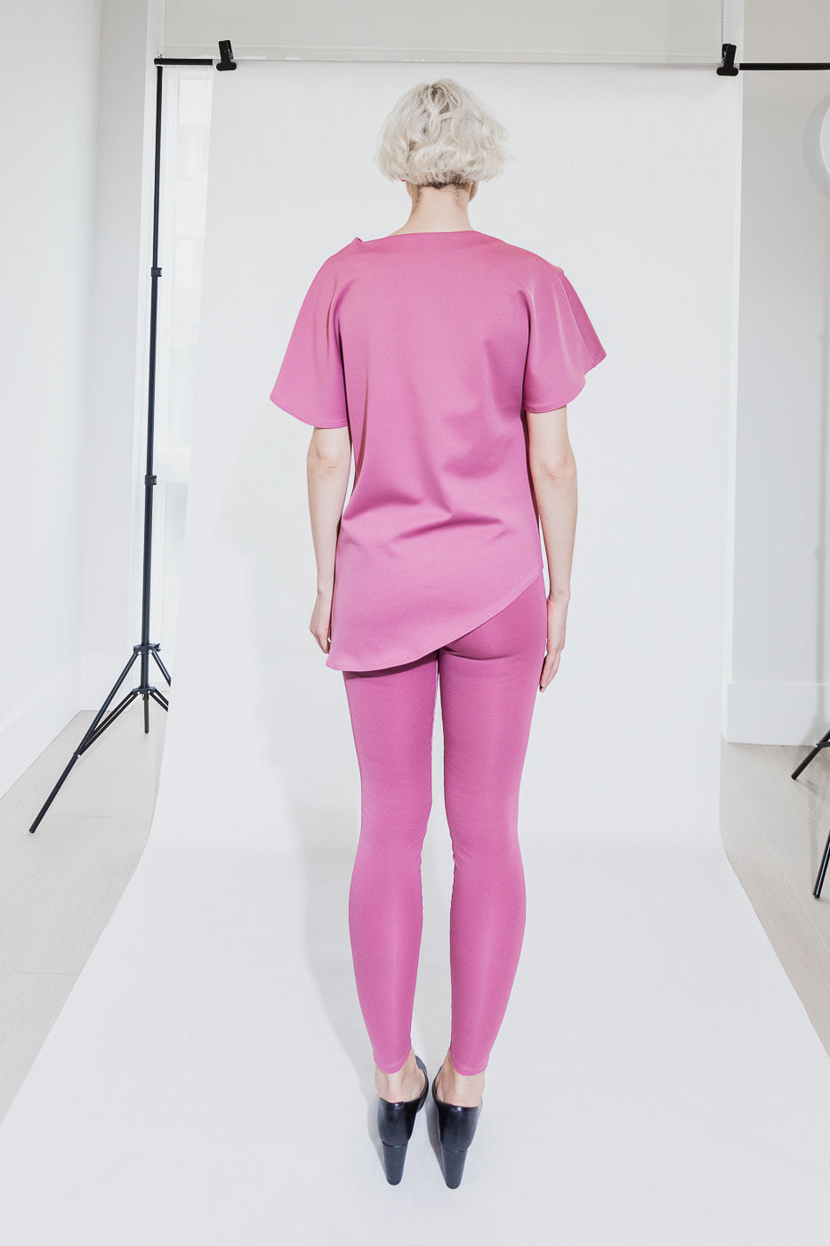 Pink asymmetrical top and leggings set (person)