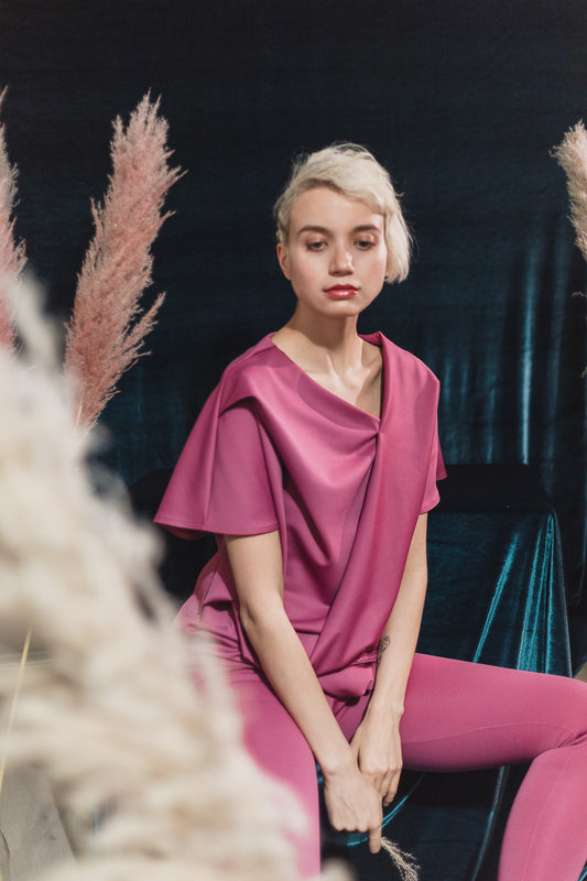 Pink draped jumpsuit with asymmetrical neckline (person)