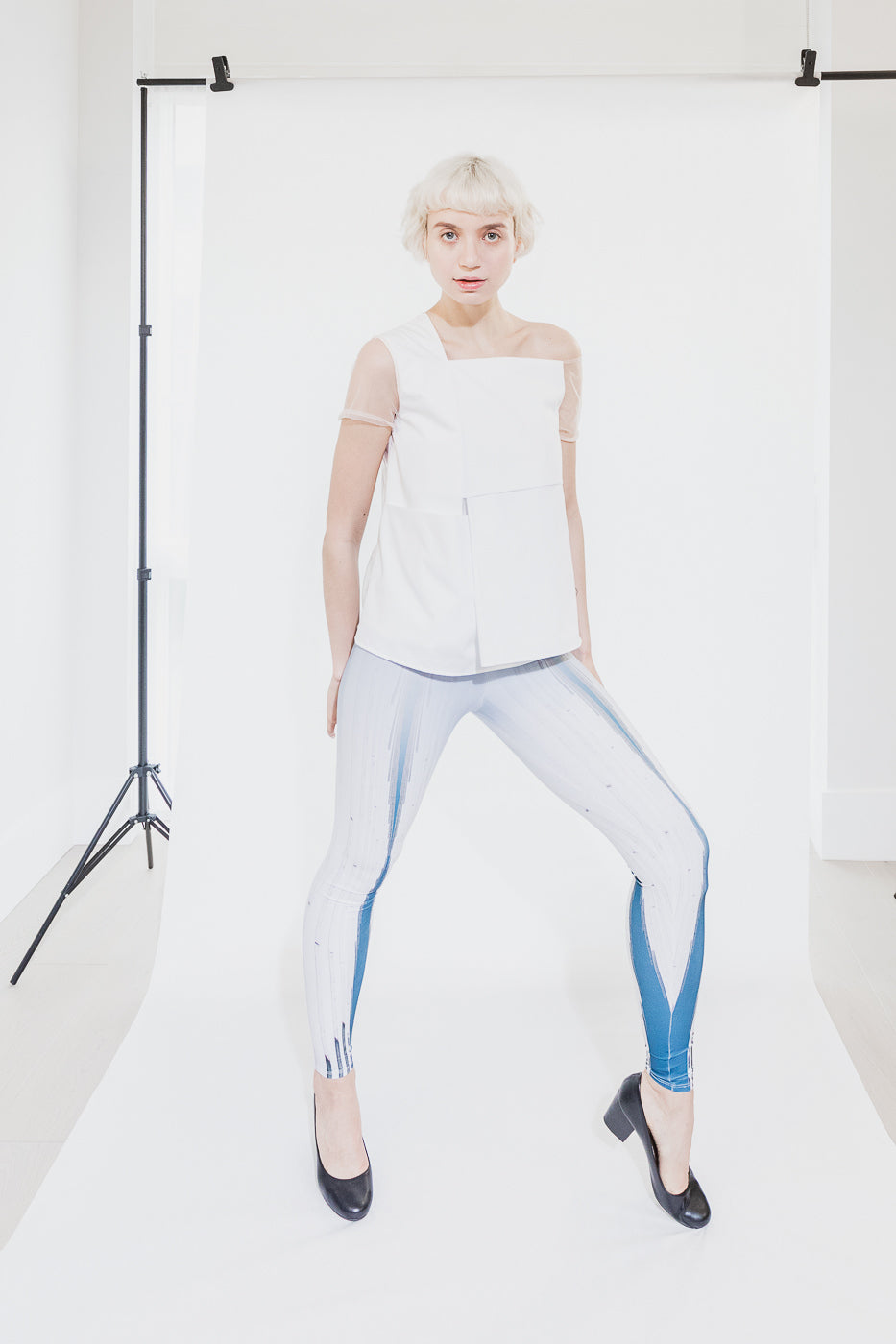 White sleeveless top with sheer sleeves (person)