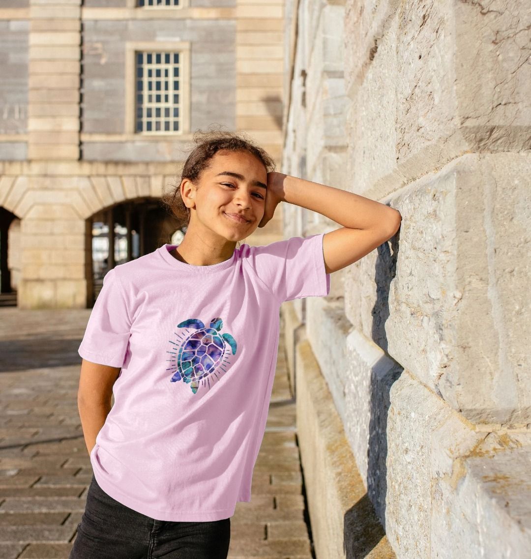 Pink t-shirt with turtle graphic (person)