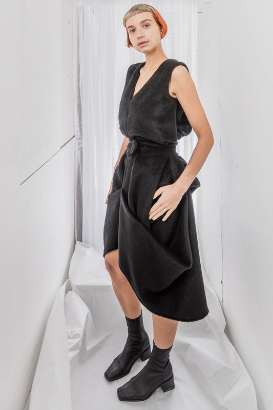 Black sleeveless wrap dress with high-low hem (person)