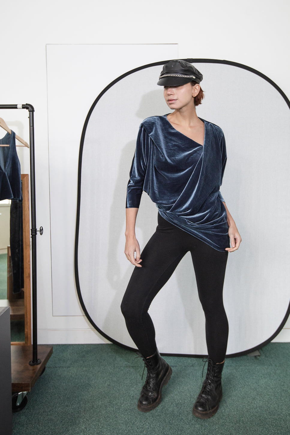 Blue velvet wrap top with black leggings and boots (person)