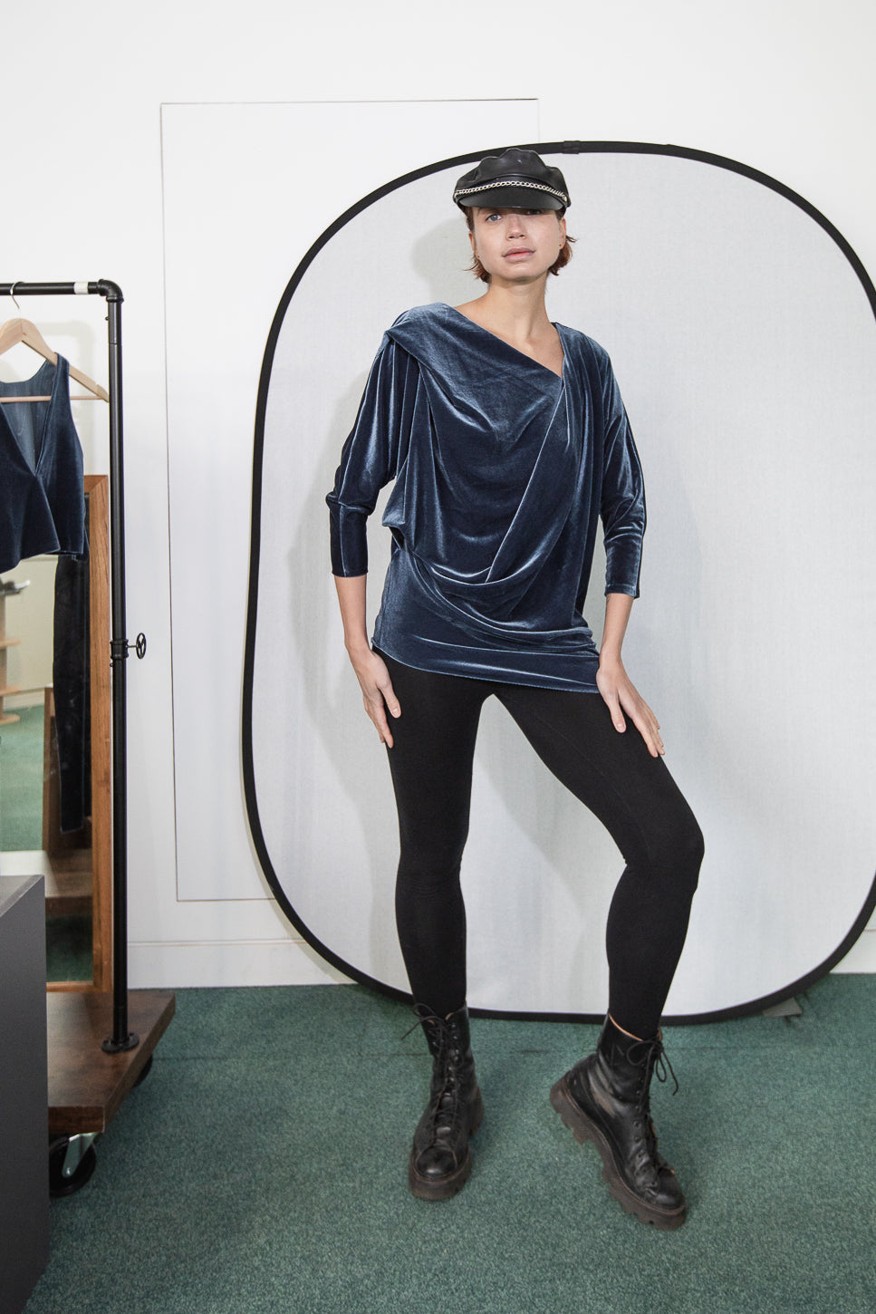 Velvet draped top with black leggings and boots (person)