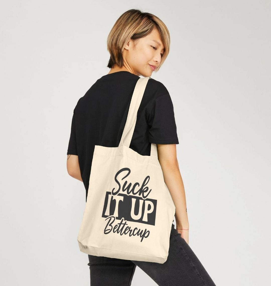 Natural canvas tote bag with "Suck It Up Bettercup" text (person)