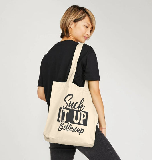 Natural canvas tote bag with "Suck It Up Bettercup" text (person)