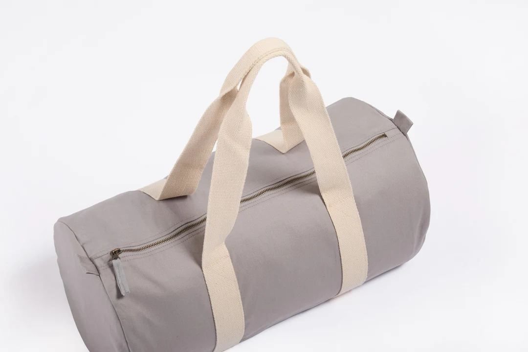Gray cylindrical duffel bag with beige handles