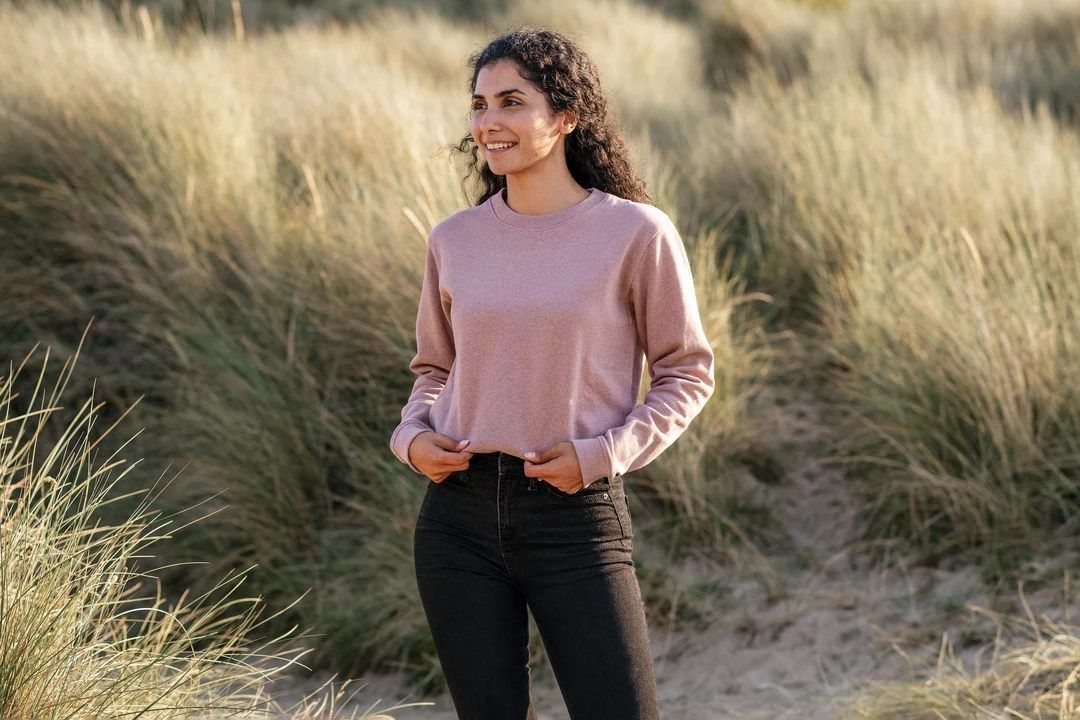 Pink long-sleeve sweater with relaxed fit (person)