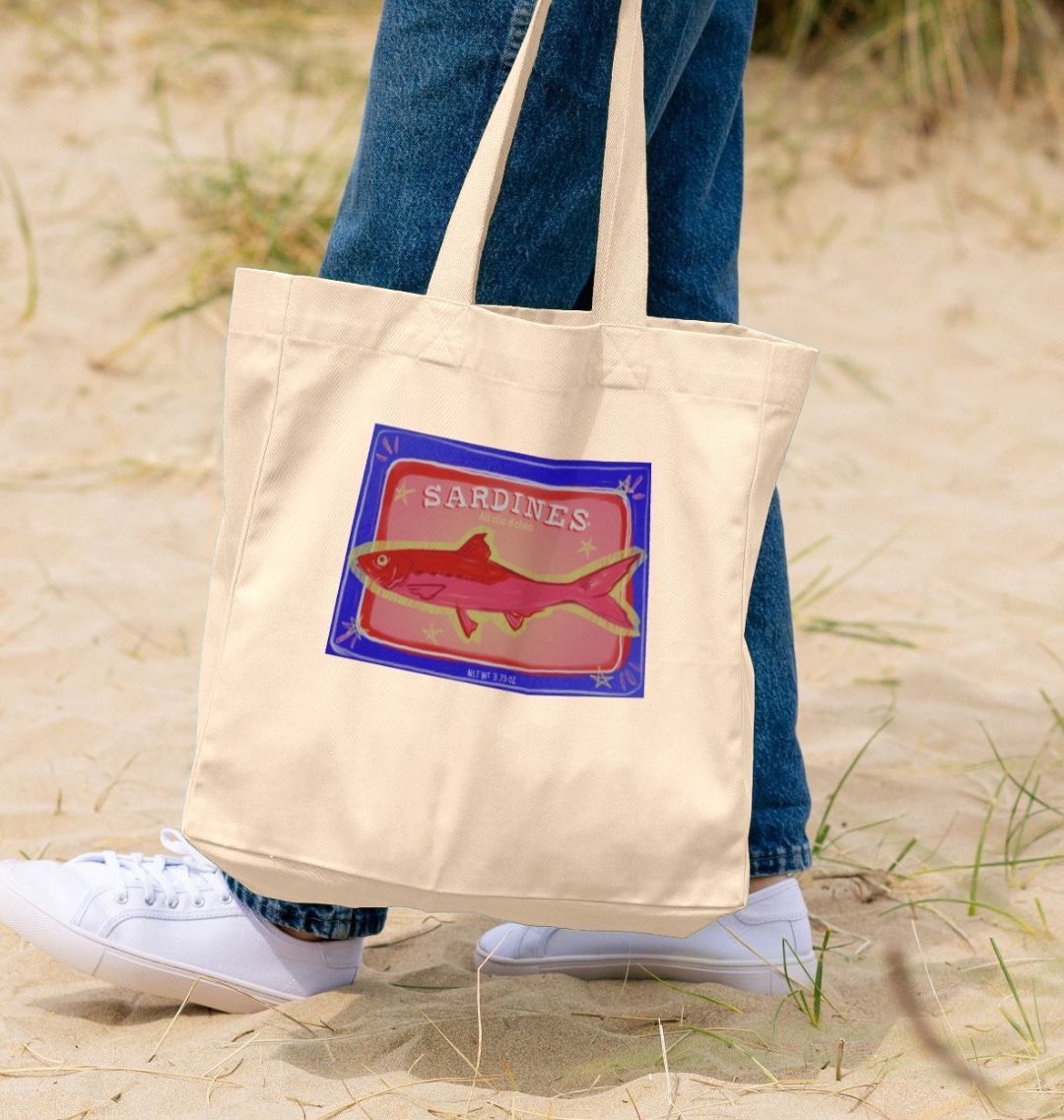 Natural canvas tote bag with "SARDINES" and fish design (person)