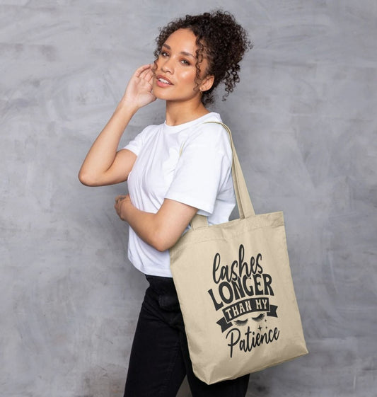 Natural cotton tote bag with "Lashes Longer Than My Patience" text (person)
