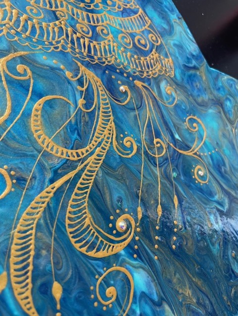 Gold and blue abstract art with intricate swirls