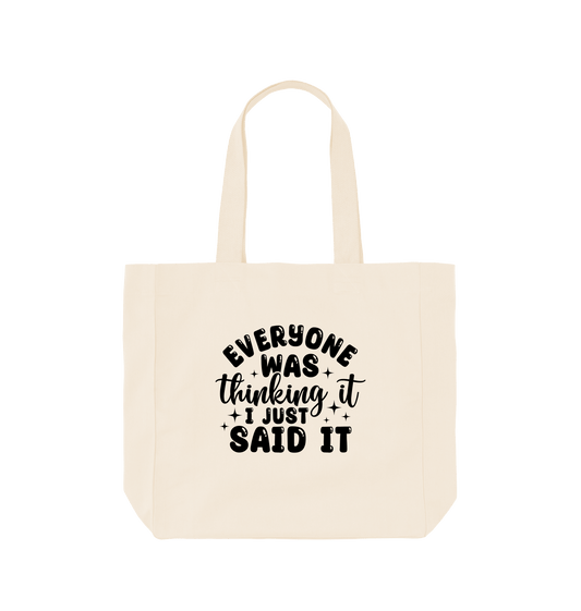 White tote bag with black text