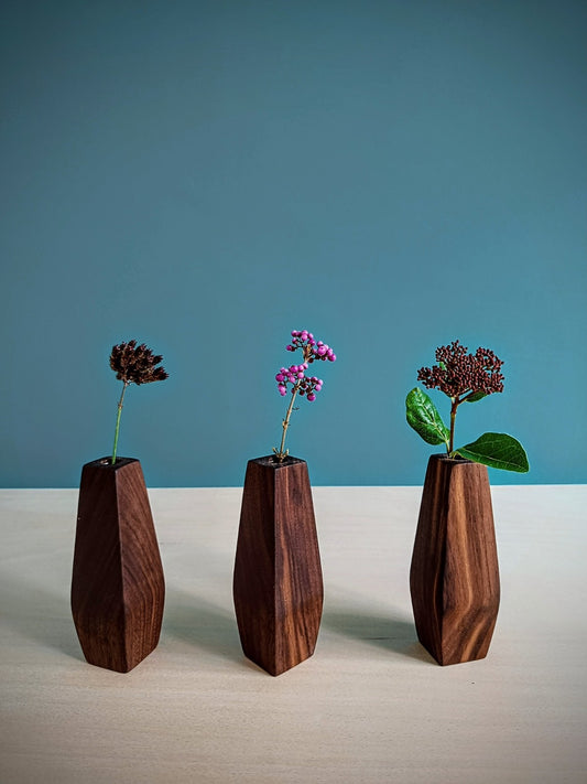 Three wooden vases with flowers