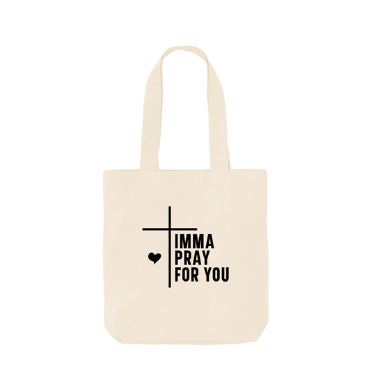 White tote bag with "IMMA PRAY FOR YOU" text and cross