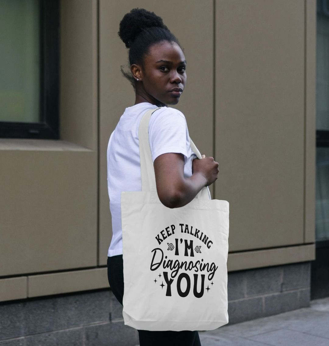 White tote bag with "Keep Talking I'm Diagnosing You" text (person)