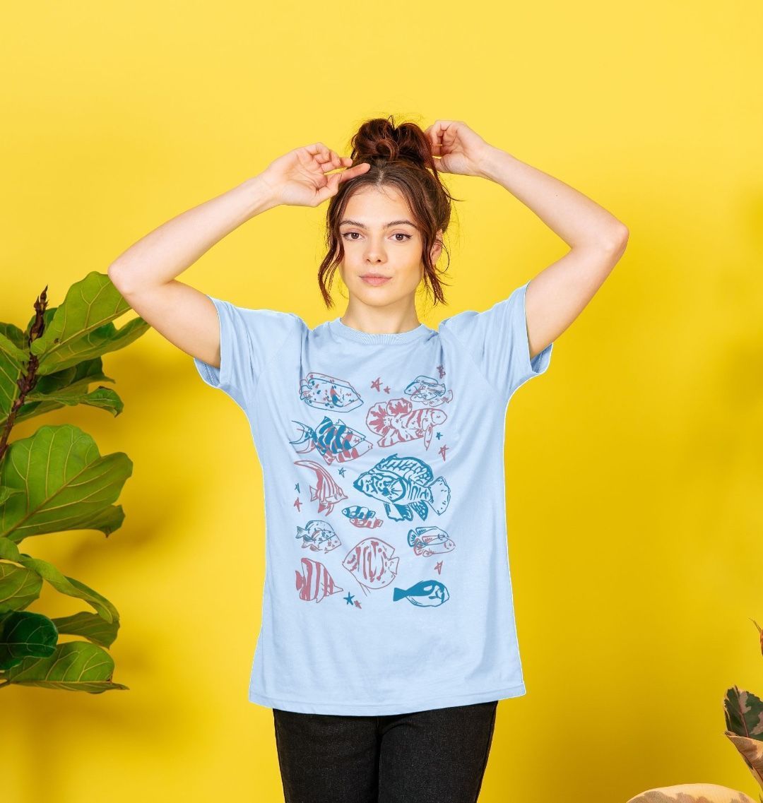 Light blue t-shirt with colorful fish designs (person)