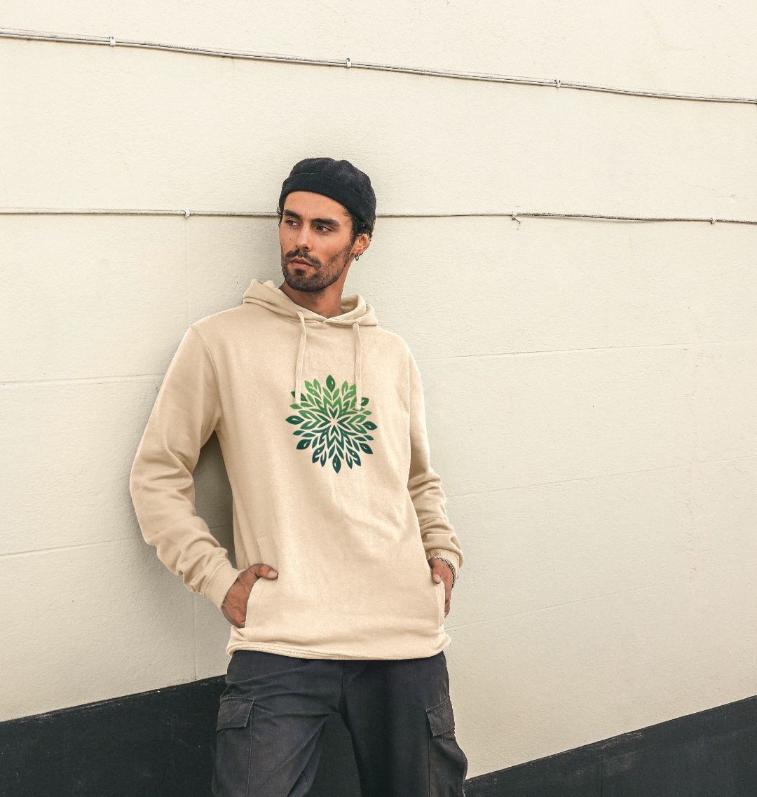 Beige hoodie with green leaf design (person)