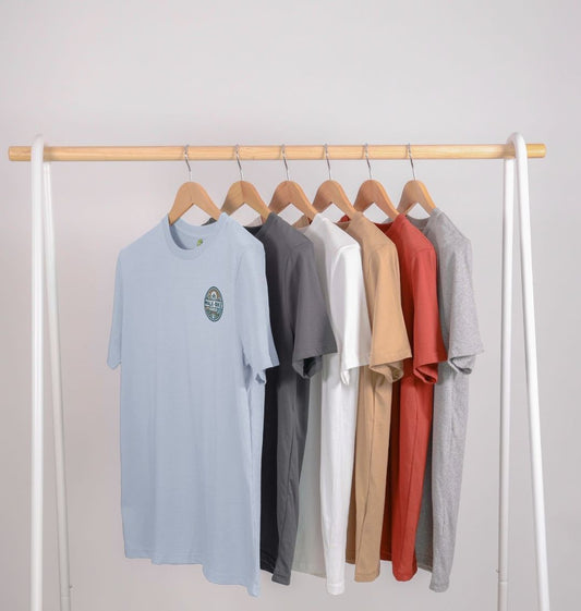 Assorted color t-shirts on a wooden hanger