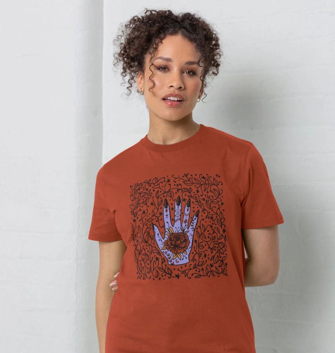 Rust-colored t-shirt with floral hand design (person)