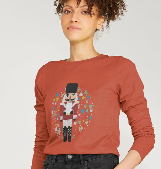 Rust-colored long-sleeve sweatshirt with nutcracker design (person)
