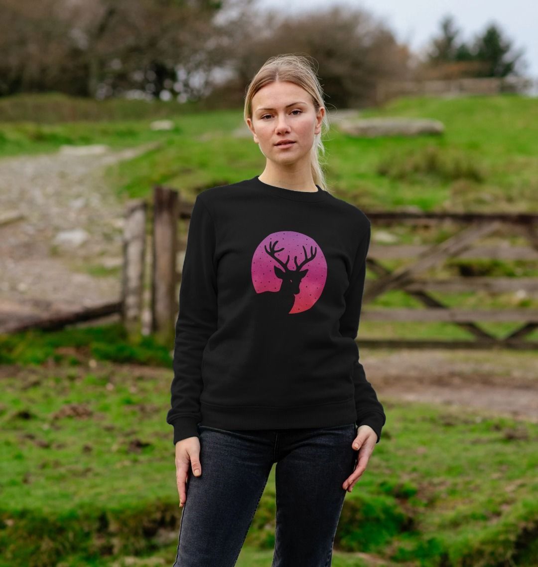 Black sweatshirt with deer silhouette and pink moon design (person)