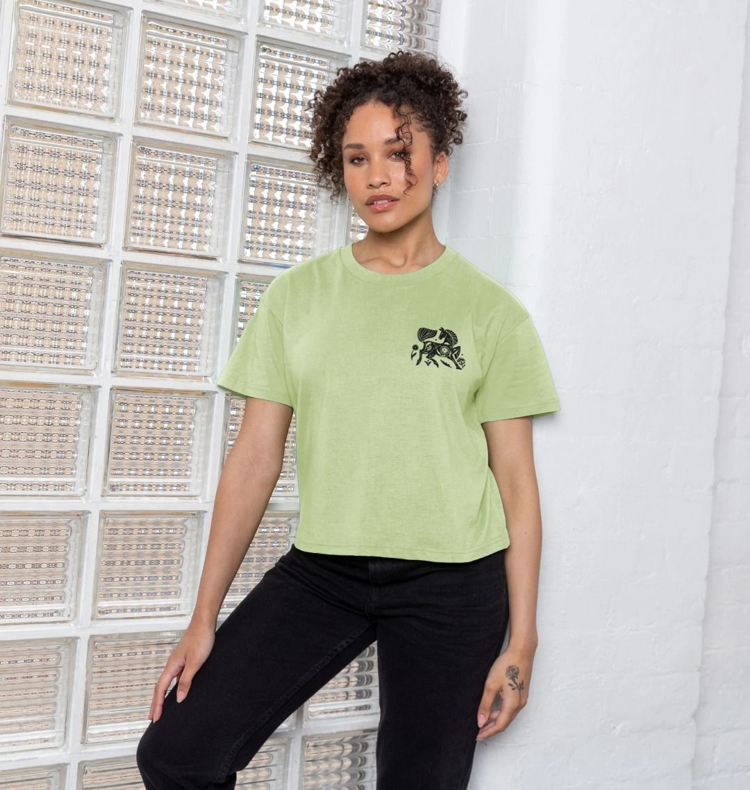 Light green cropped t-shirt with black embroidered design (person)