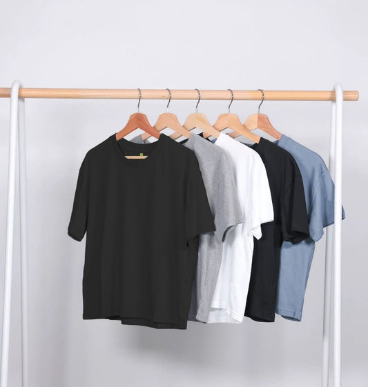 Five plain t-shirts on hangers