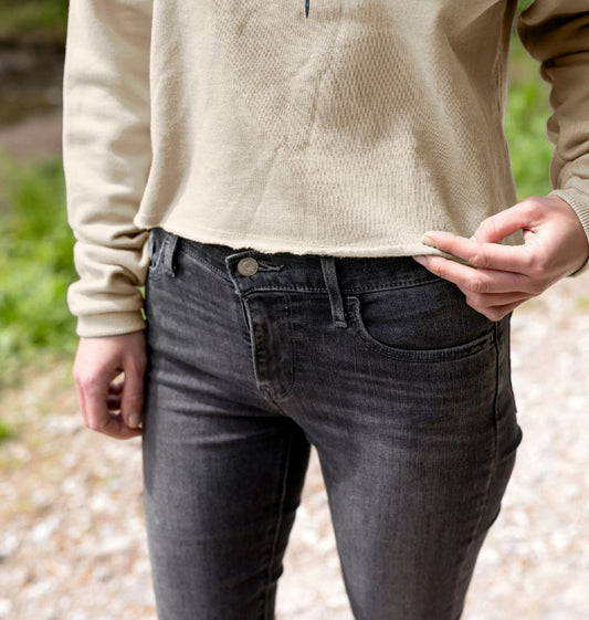 Dark gray skinny jeans with button fly (person)