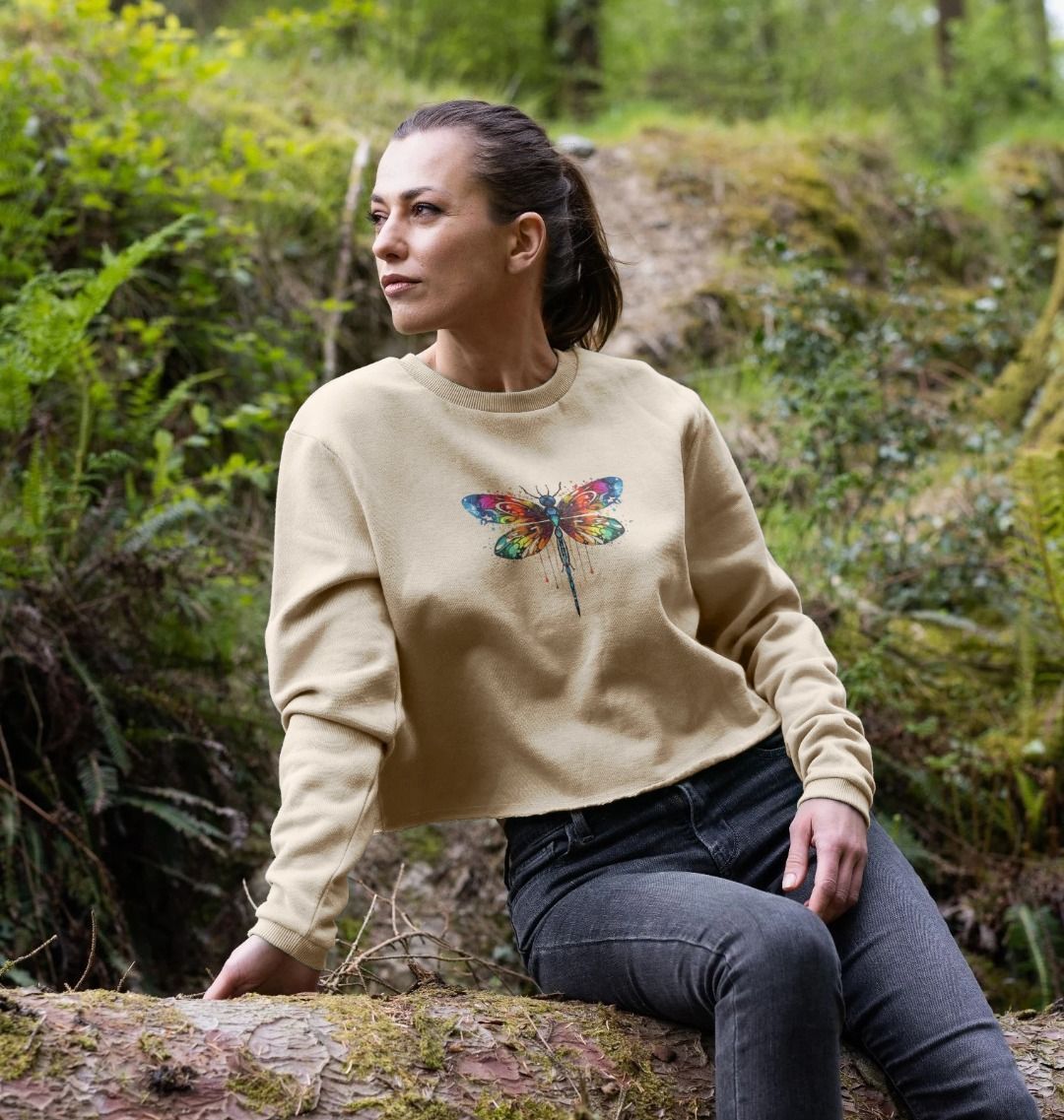 Beige sweatshirt with colorful dragonfly design (person)