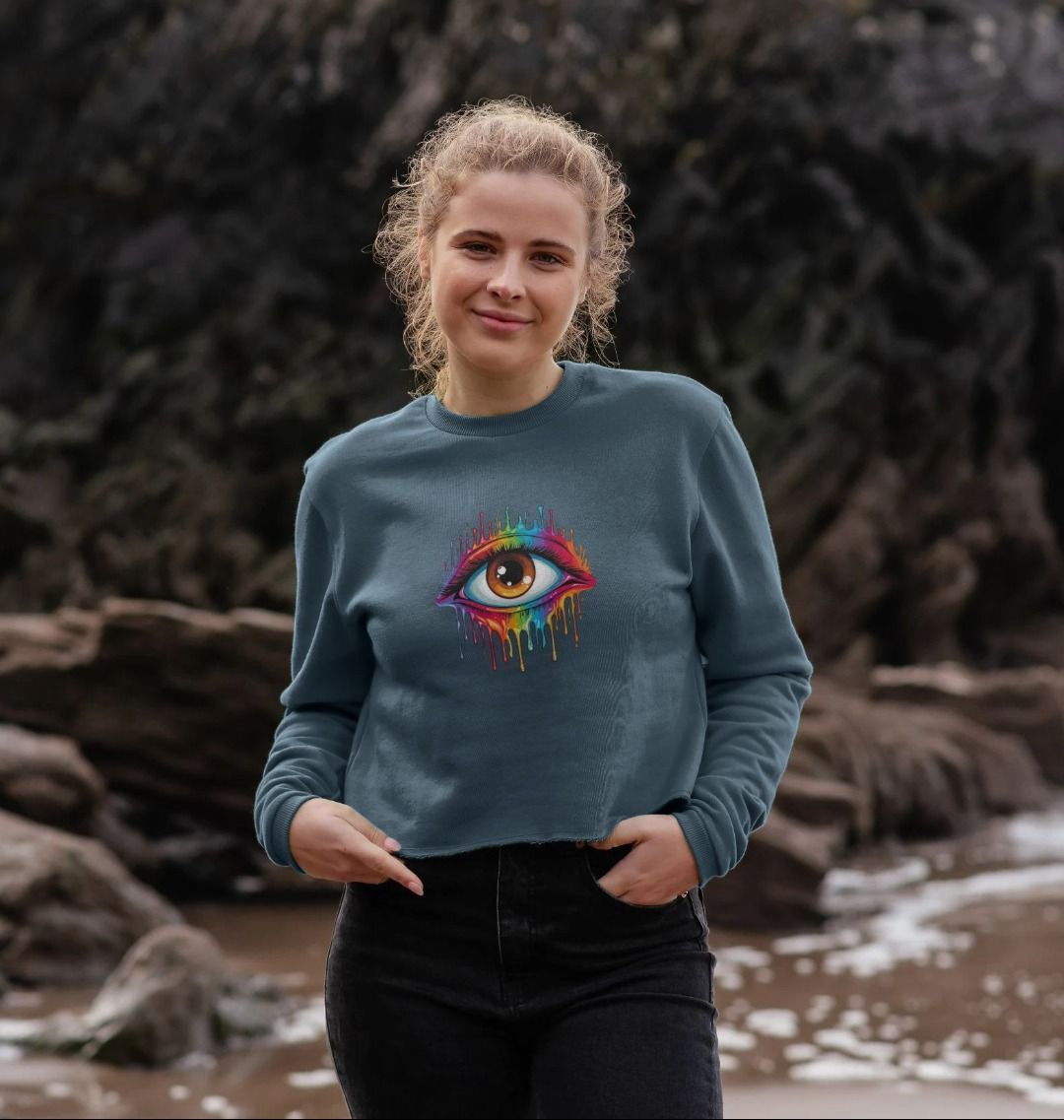 Blue sweatshirt with colorful eye graphic (person)