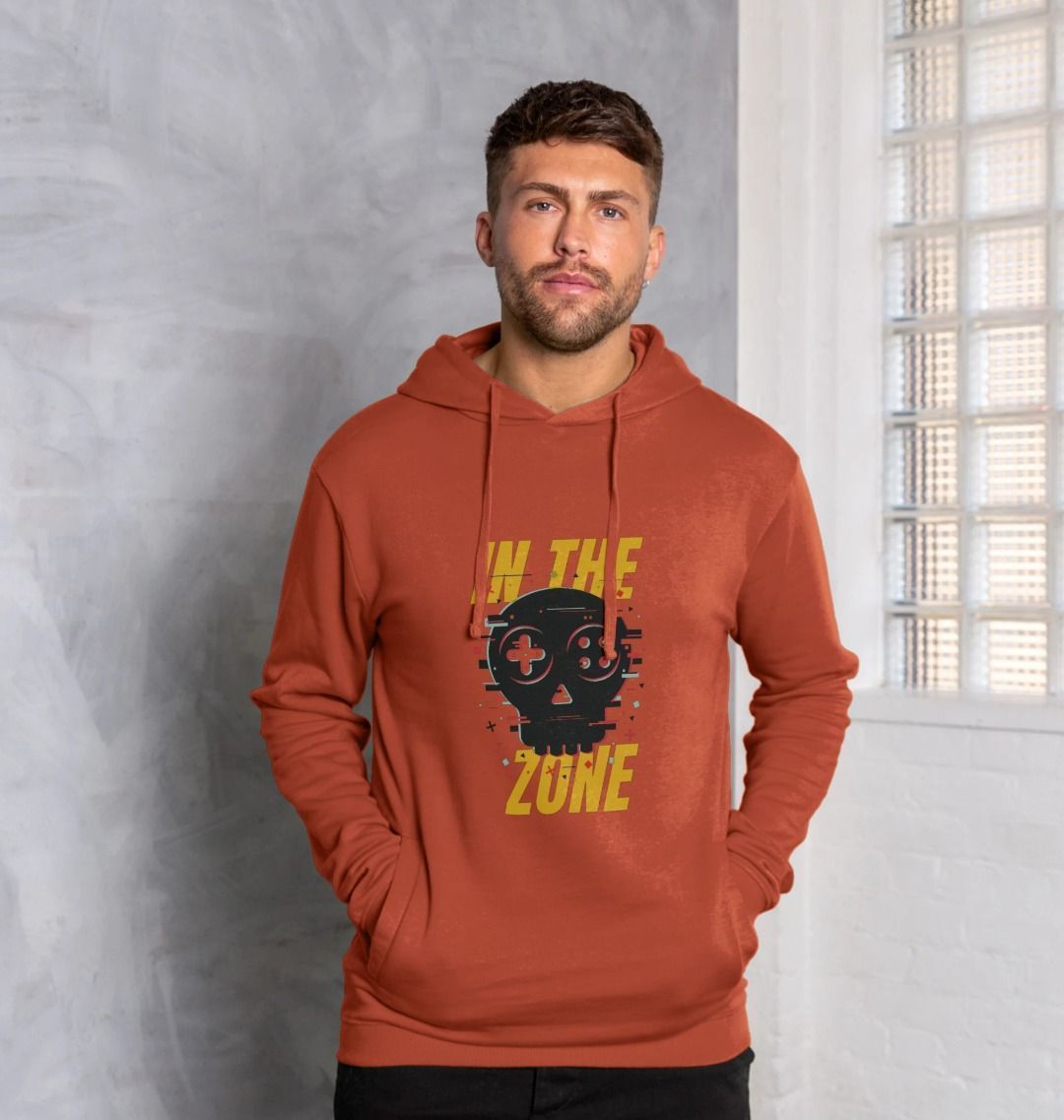 Burnt orange hoodie with skull and controller graphic (person)