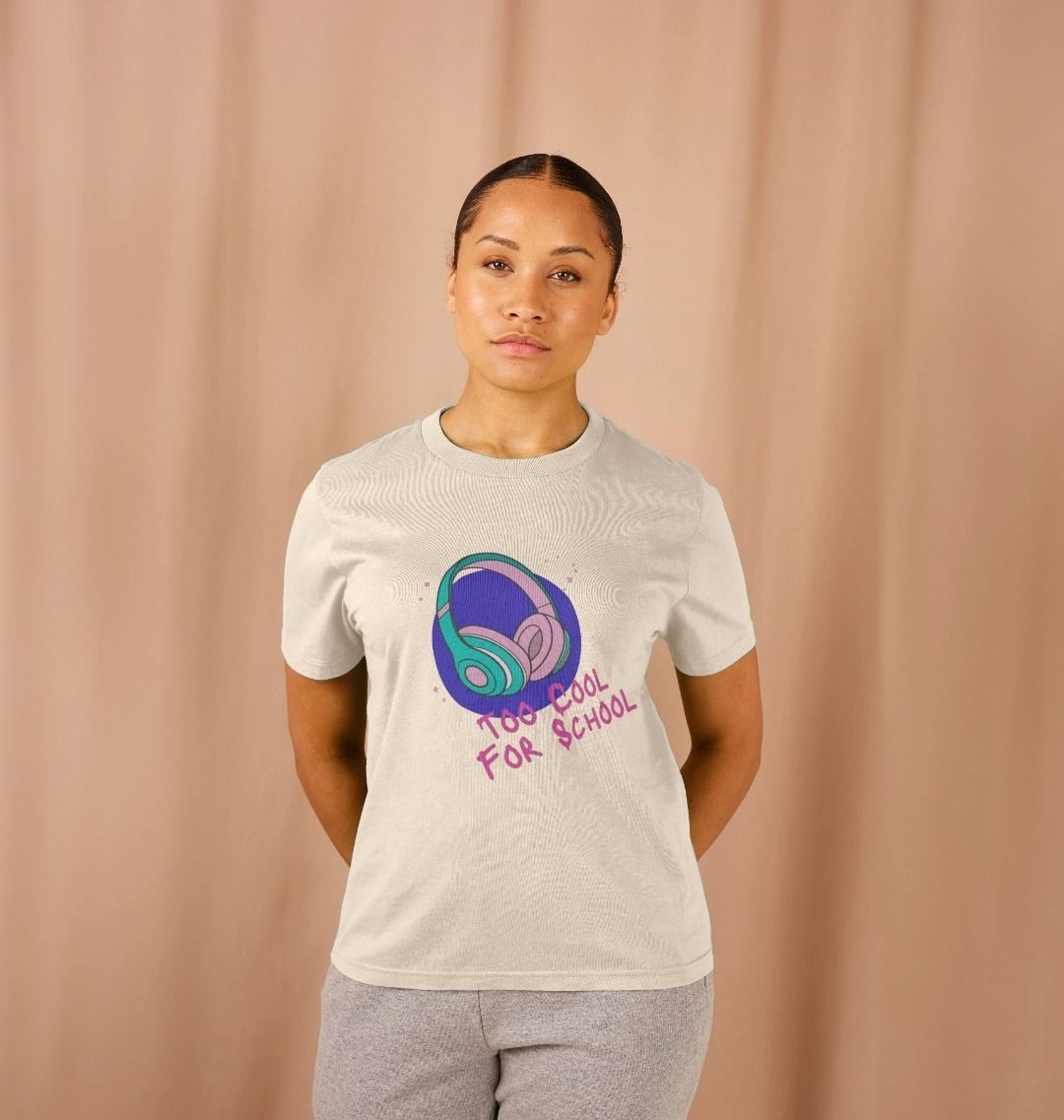 White t-shirt with "Too Cool For School" text and headphones graphic (person)
