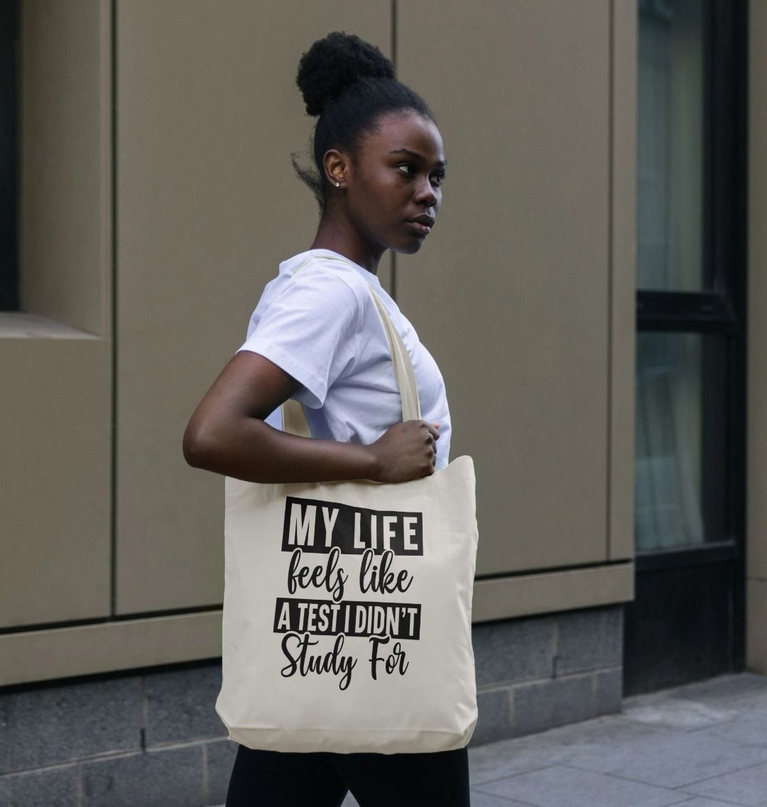 White tote bag with text "MY LIFE feels like a test I didn't Study For" (person)