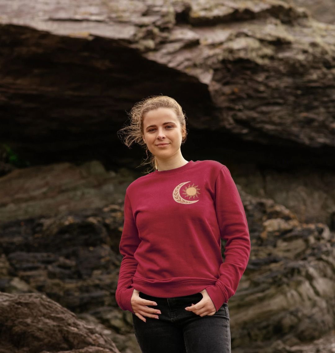 Maroon sweatshirt with sun and moon design (person)