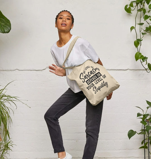 Natural canvas tote bag with "Sarcasm depends on your level of stupidity" text (person)