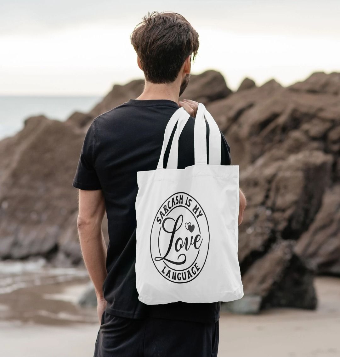 White tote bag with "Sarcasm is my love language" text (person)