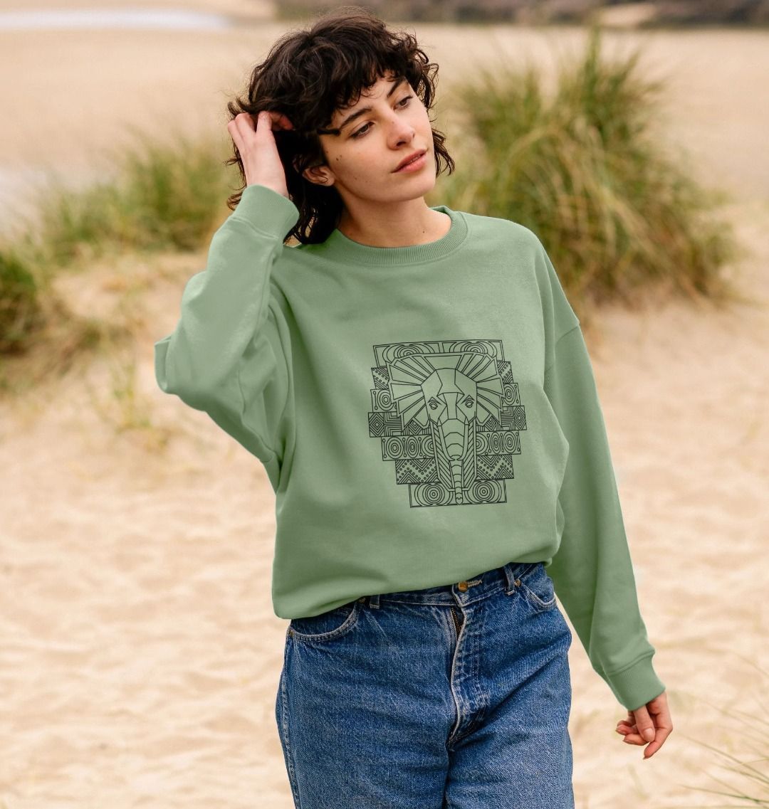 Sage green sweatshirt with elephant graphic (person)