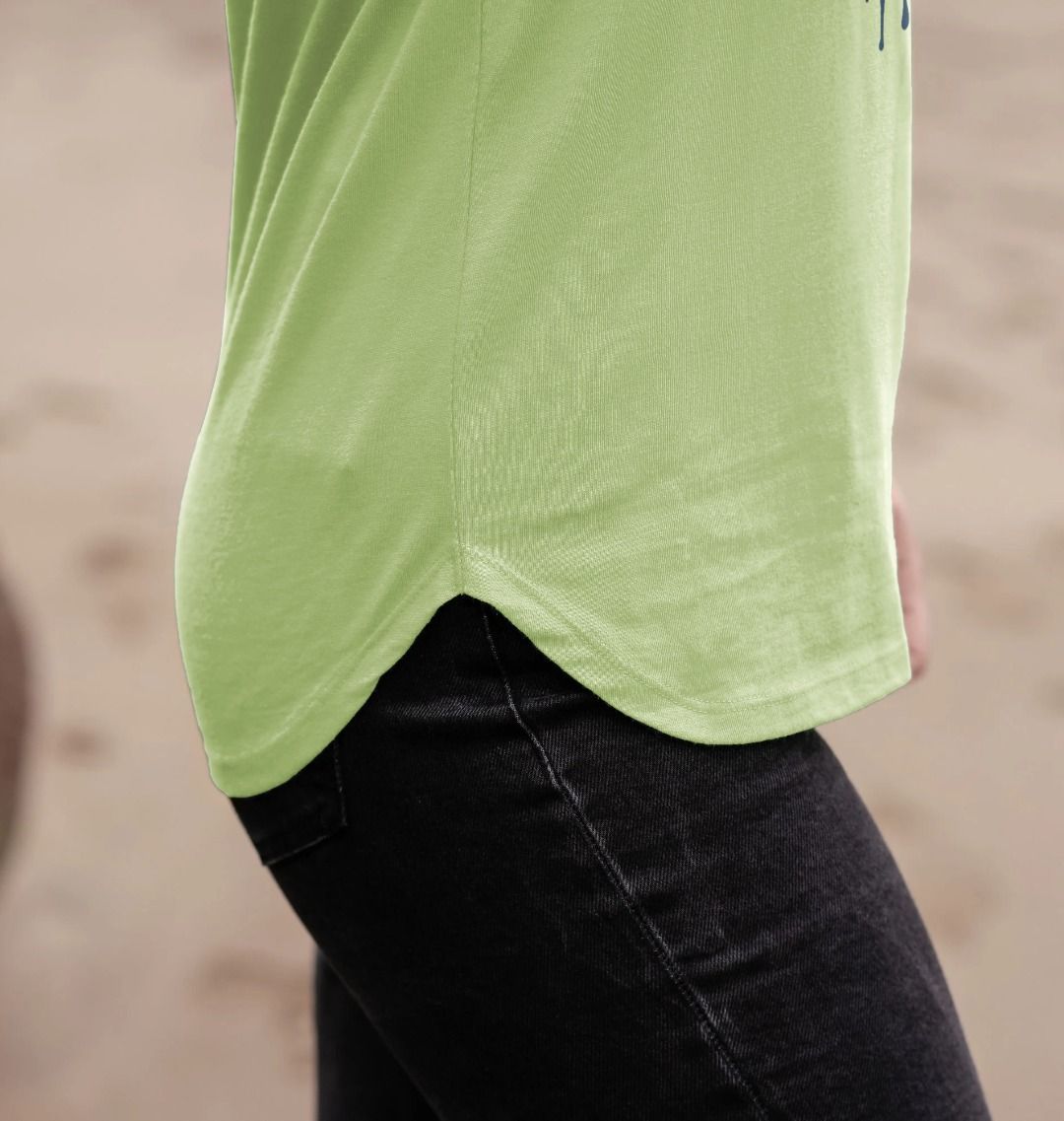 Lime green long-sleeve top with black jeans (person)