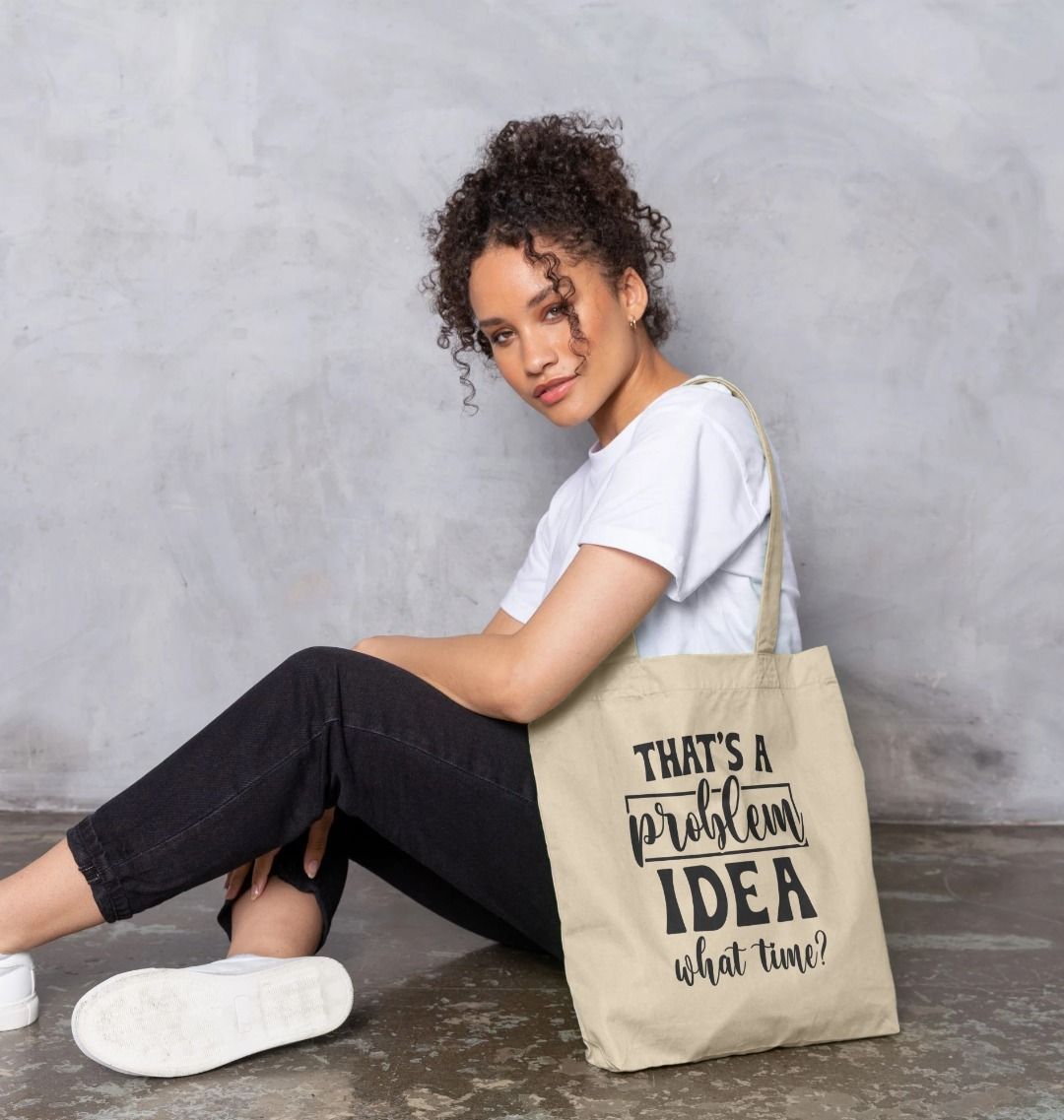 Natural cotton tote bag with text "THAT'S A problem IDEA what time?" (person)