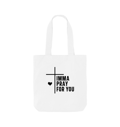 White tote bag with "IMMA PRAY FOR YOU" text and cross