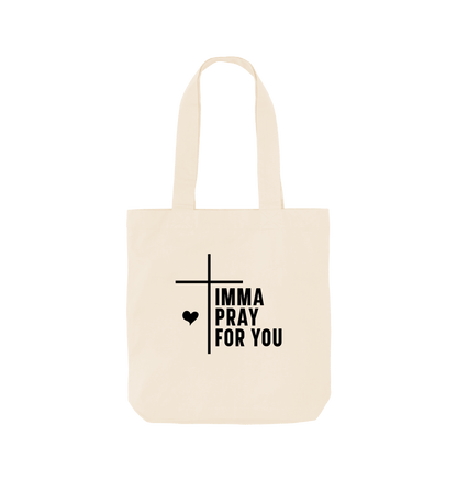 White tote bag with "IMMA PRAY FOR YOU" text and cross