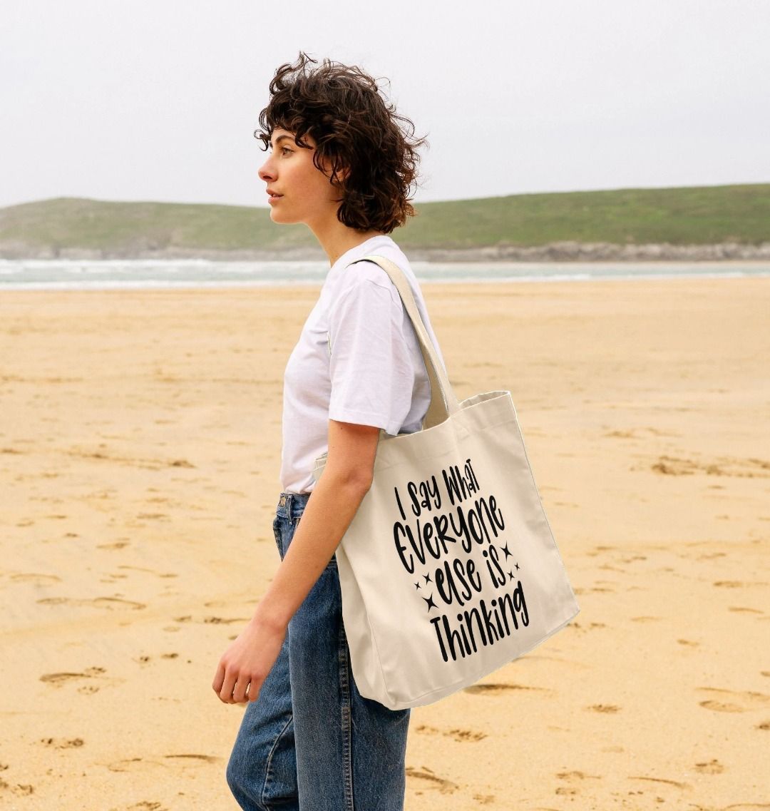 White tote bag with black text (person)